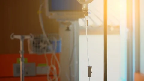 Saline dropping solution tube on white bright background in hospital Stock Footage 98411527