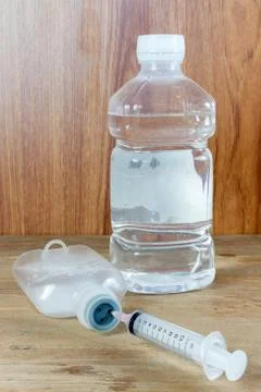 Saline solution and injection needle Stock Photos