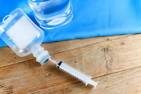Saline solution and injection needle Stock Photos