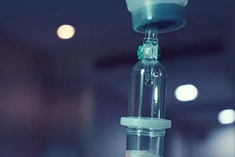 Saline solution drip for patient and infusion pump in hospital, close up eq.. Foto stock