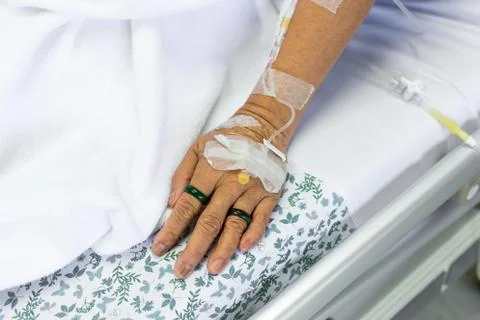 Saline solution to patient hand Stock Photos