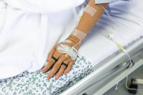 Saline solution to patient hand Stock Photos