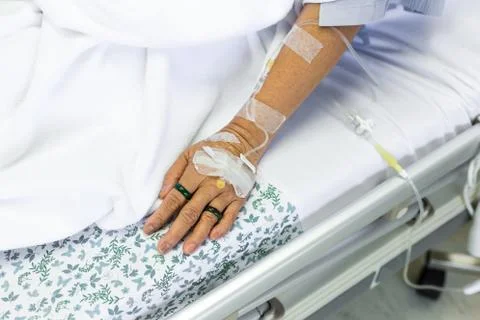 Saline solution to patient hand Stock Photos
