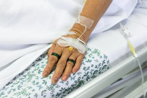 Saline solution to patient hand Stock Photos