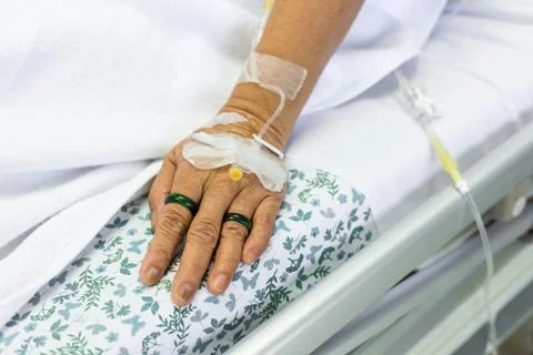 Saline solution to patient hand Stock Photos