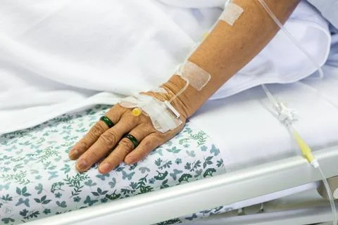 Saline solution to patient hand Stock Photos
