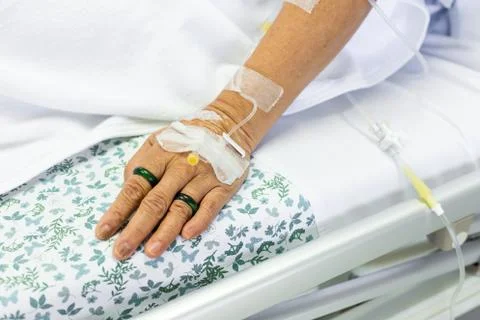 Saline solution to patient hand Stock Photos