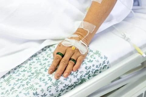 Saline solution to patient hand Stock Photos