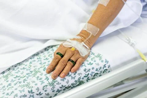 Saline solution to patient hand Stock Photos
