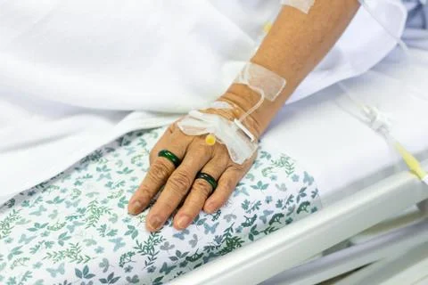 Saline solution to patient hand Stock Photos