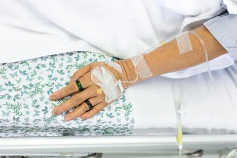 Saline solution to patient hand Stock Photos