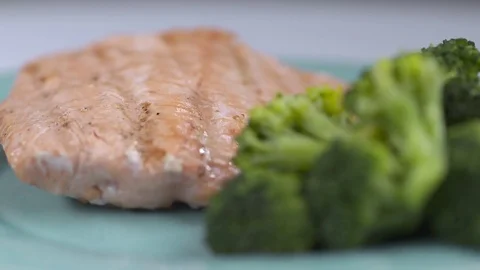 Salmon and broccoli spin in slow motion close up. Stock Footage 72544556