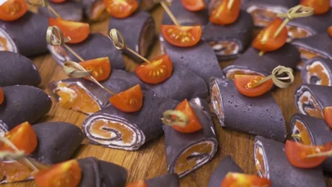 Salmon and cherry tomato canapes on a round wooden serving board 스톡 동영상 314853949