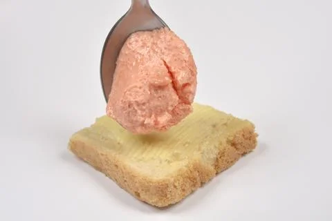Salmon and fish roe spread on a spoon over bread Stock Photos