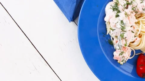 Salmon baked in cream cheese sauce with italian pasta and vegeta Stock Footage