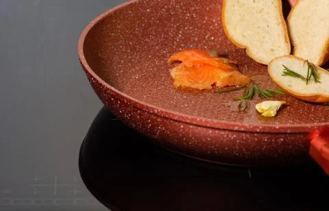 Salmon, bread, garlic, frying pan, rosemary Stock Photos