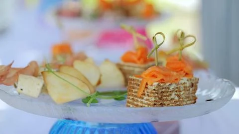 Salmon canapes and cheese appetizers garnished with pear slices, elegantly Stock-Fotos