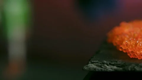 Salmon caviar on a black plate Video stock 102708683