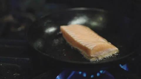 Salmon cooking in a pan in slow motion Stock Footage 131759906