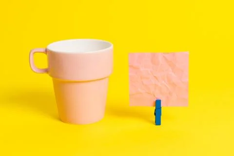 Salmon cup and a empty note paper pinned in a blue clothespin. Square rectangle Foto stock