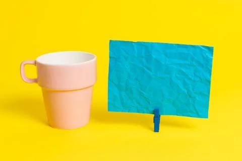 Salmon cup and a empty note paper pinned in a blue clothespin. Square rectangle Foto stock