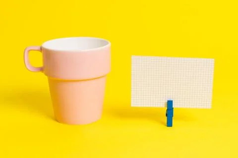 Salmon cup and a empty note paper pinned in a blue clothespin. Square rectangle Foto stock