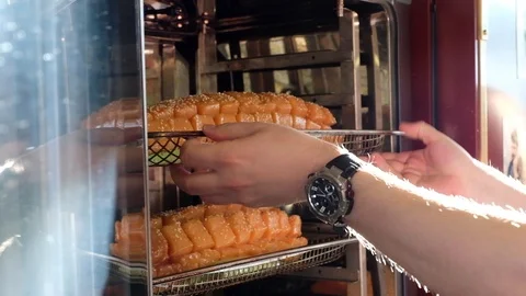 The salmon cut into cubes is put in the oven for baking on a special baking tray Stock Footage 91194705