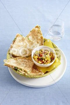 Salmon-filled tortillas with a sweetcorn salad Stock Photos