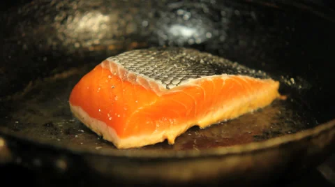 Salmon fillet frying in pan Stock Footage 33045979