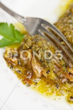 Salmon fillet with a herb crust being cut Stock Photos