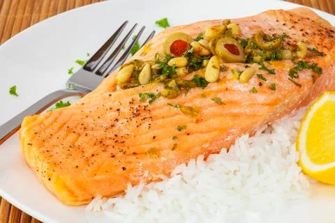Salmon fillet with pine nuts Stock Photos