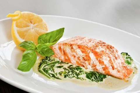 Salmon fillet with spinach Stock Photos