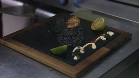 Salmon fillets and black risotto. professional Serving Stockbeeldmateriaal 72321144