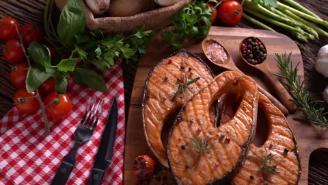 Salmon fish steak with herbs and vegetables on wooden background Stockbeeldmateriaal 148803765