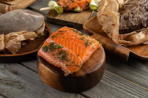 Salmon fish. Uncooked salmon fillet with lemon sea salt and dill on wooden plank Stock Photos