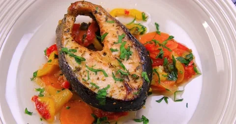 Salmon fish with vegetables ready to be served Stock Footage 163434237