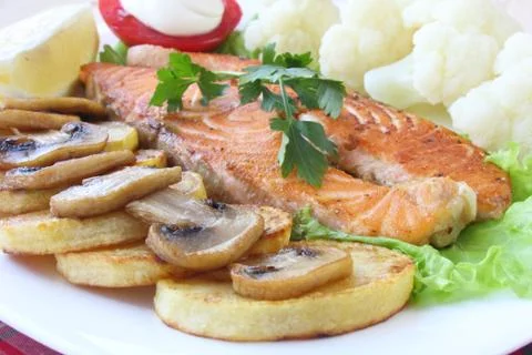 Salmon with garnish Stock Photos