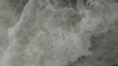 Salmon migrating back to spawning grounds and leaping over dam Stock Footage 117349058