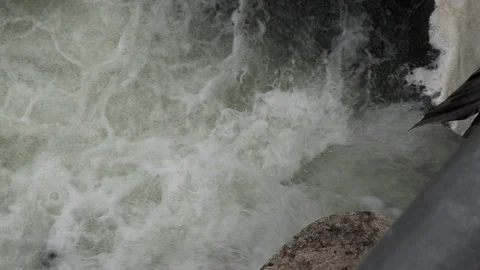 Salmon migrating back to spawning grounds and leaping over dam Stock Footage 117351507