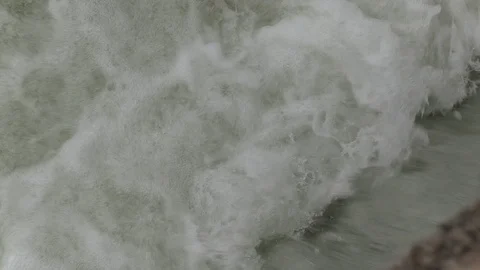 Salmon migrating back to spawning grounds and leaping over dam Stock Footage 117351894