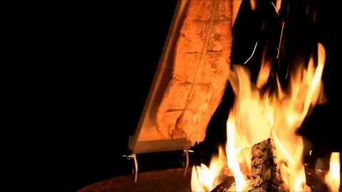 Salmon on open fire, close up, flammlachs Stock Footage