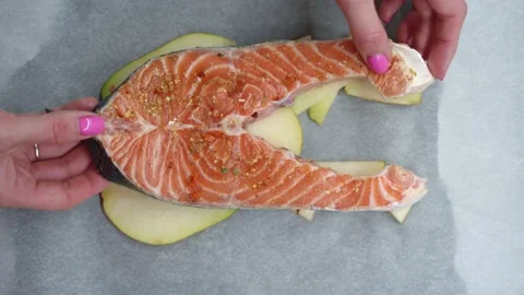 Salmon on a pear prepares to go to the oven 스톡 동영상 130943353