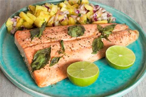 Salmon with pineapple salsa and lime Stock Photos