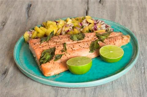 Salmon with pineapple salsa and lime Stock Photos
