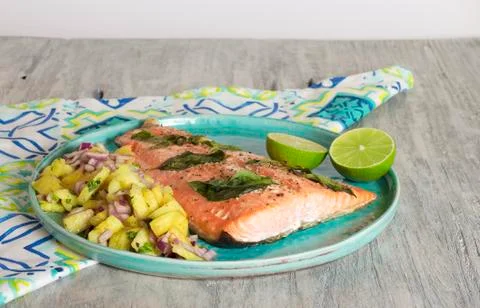 Salmon with pineapple salsa and lime Stock Photos