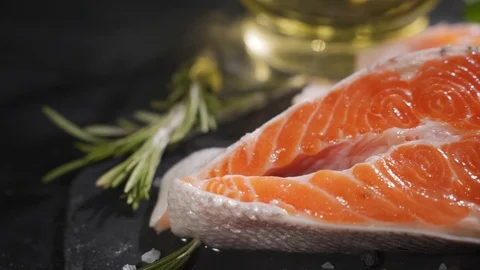 Salmon. Raw Trout Red Fish Steak with Herbs and Lemon and olive oil on slate. Stock Footage 116536079
