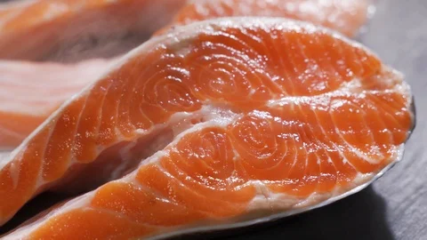 Salmon. Raw Trout Red Fish Steak rotated on slate. Stock Footage 116591099