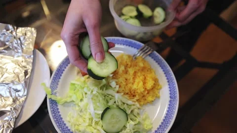 Salmon, rice, cabbage and cucumber salad on a large plate for dinner Vídeos de archivo 233210360