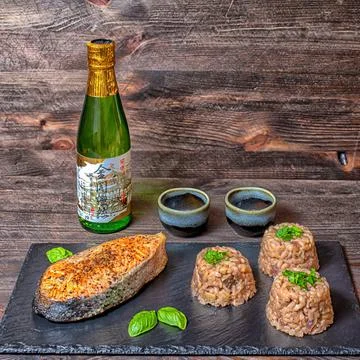 Salmon risotto sake glasses basil Stock Photos