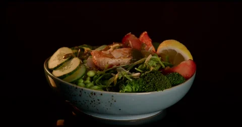 Salmon Salad With Lemon and Broccoli Rotating on Black Background Stock Footage 340111734